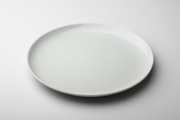 Empty round white plate with smooth edge