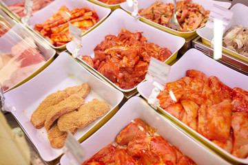 marinated meat in bowls at grocery stall
