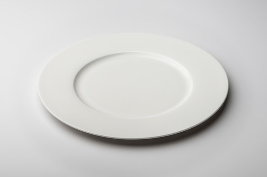 Empty round white plate with smooth edge
