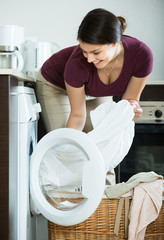 Young woman  near washing machine