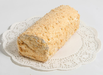 Sponge cake with cream on a white napkin.