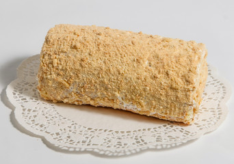 Sponge cake with cream on a white napkin.