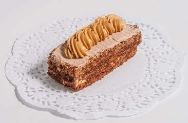 Sponge cake with cream on a white napkin.