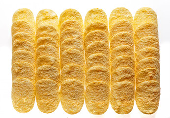 Potato chips stacked in rows. Texture.
