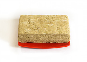 Paste briquette on a red plate isolated.