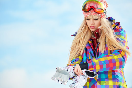 Sport girl with snowboard high in the winter snowy mountains. 