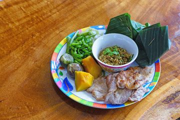 Thai food , Green chili dip as Nam Prik Num in Thai with crispy pork rind ,spicy pepper,boiled cow-pea and sliced cucumber.