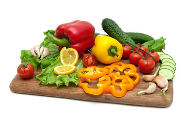 fresh vegetables on a cutting board on a white background