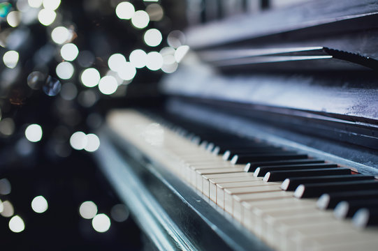 The old black piano. close-up of keys. Beautiful blur