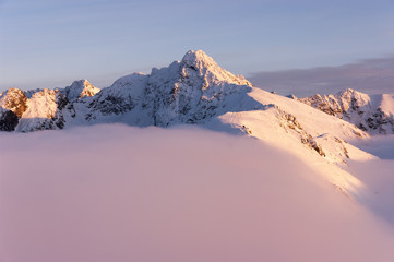 Big mountain peaks at sunset and inversion.