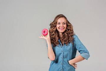 The smiling girl on gray studio background with round cake