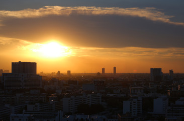 Sunset and clouds background in the evening, city downtown with sunset sky