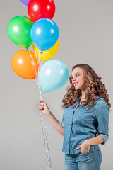 girl with bunch of colorful balloons