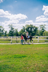 couple and horse at a farm ridding and kissing each other.