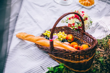 Picnic in the spring summer forest without people. Fresh bread and fruits.