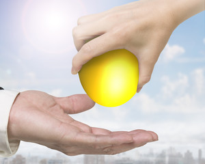 Hand giving one golden egg