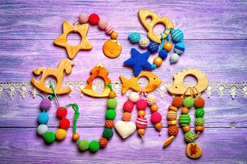 group of handmade toys for toddlers on a wooden background with lace