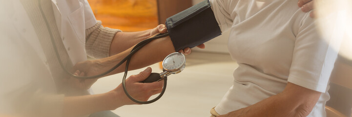 Doctor measures blood pressure