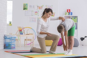 Child exercising with physiotherapist