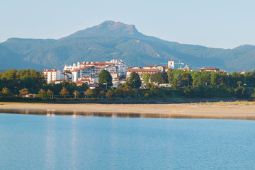 Fototapeta premium seascape. Bay with blue water on the background of the city of Hendaye. the French part of the Basque country