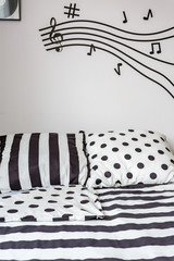 Striped and dotted sheet on bed