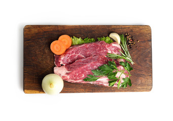 raw steak on a cutting board.top view