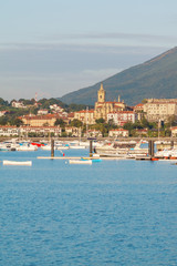 seascape of bay with blue water and yachts. view of the town of Irun, Spain