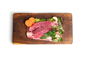 raw steak on a cutting board.top view