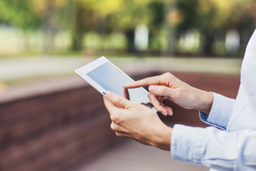 Young girl using digital tablet outdoors