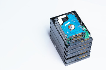 stack of old hard drives on white background