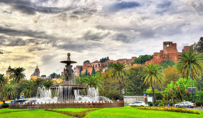 Tres Gracias Fountain and Alcazaba Castle in Malaga - Adalusia, Spain - obrazy, fototapety, plakaty
