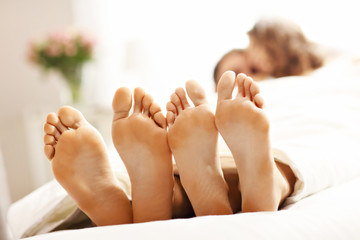 Happy couple resting in bedroom