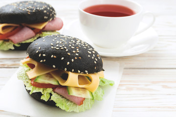 Black Hamburger , cup of tea for breakfast.