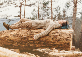 Woman lying on tree trunk outdoor