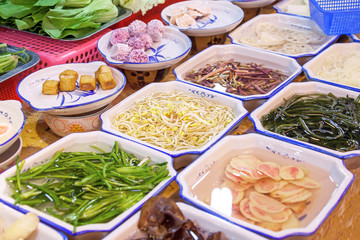 Variety of Chinese dishes at the market, Chinese street food concept.