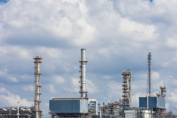 oil refinery - flare tower with a cloudy blue sky background