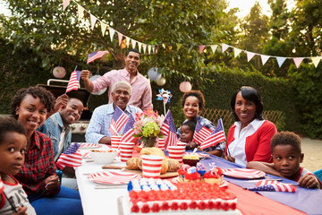 Multi generation black family having a 4th July garden party