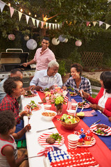 Fototapeta na wymiar Multi generation black family at 4th July barbecue, vertical