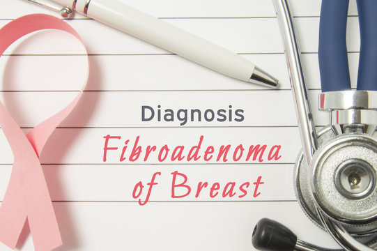 Diagnosis Fibroadenoma of Breast. Pink ribbon as symbol of struggle with breast diseases and stethoscope lying on medical form with text labels Diagnosis Fibroadenoma of Breast