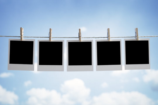 Blank instant photographs hanging on a clothesline
