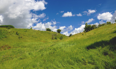 Fototapeta na wymiar Blue sky over the green hills