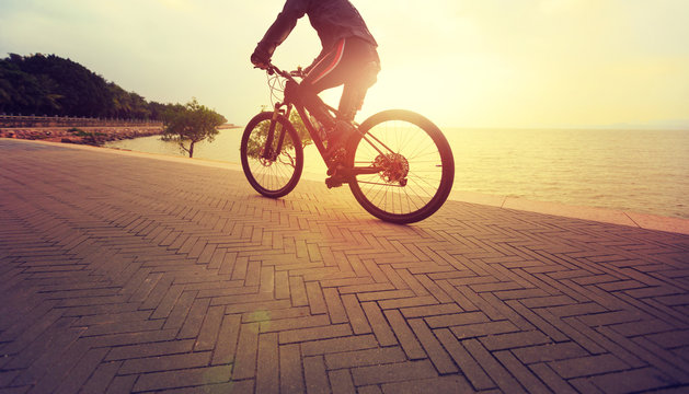 healthy lifestyle man riding bike on seaside
