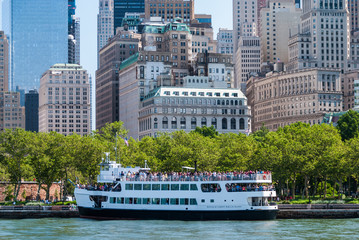Tourist cruise ship with Manhattan buildings in the background