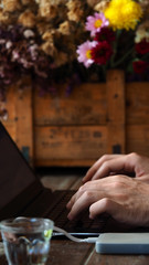 Fototapeta na wymiar Closeup man hands working on laptop in coffee shop