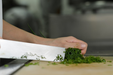 Chef training cut vegetable on cutting board with knife japan