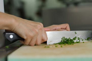 Chef training cut vegetable on cutting board with knife japan