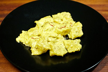 Anogllioti pasta with chicken, milk cream safran and cheese.