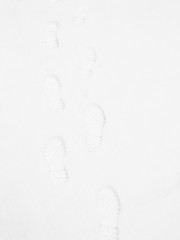 Closeup of footsteps in snow going forward