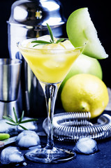 Apple cocktail with vermouth on a black background, selective fo