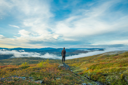 Man standing at scenic point in mountains
